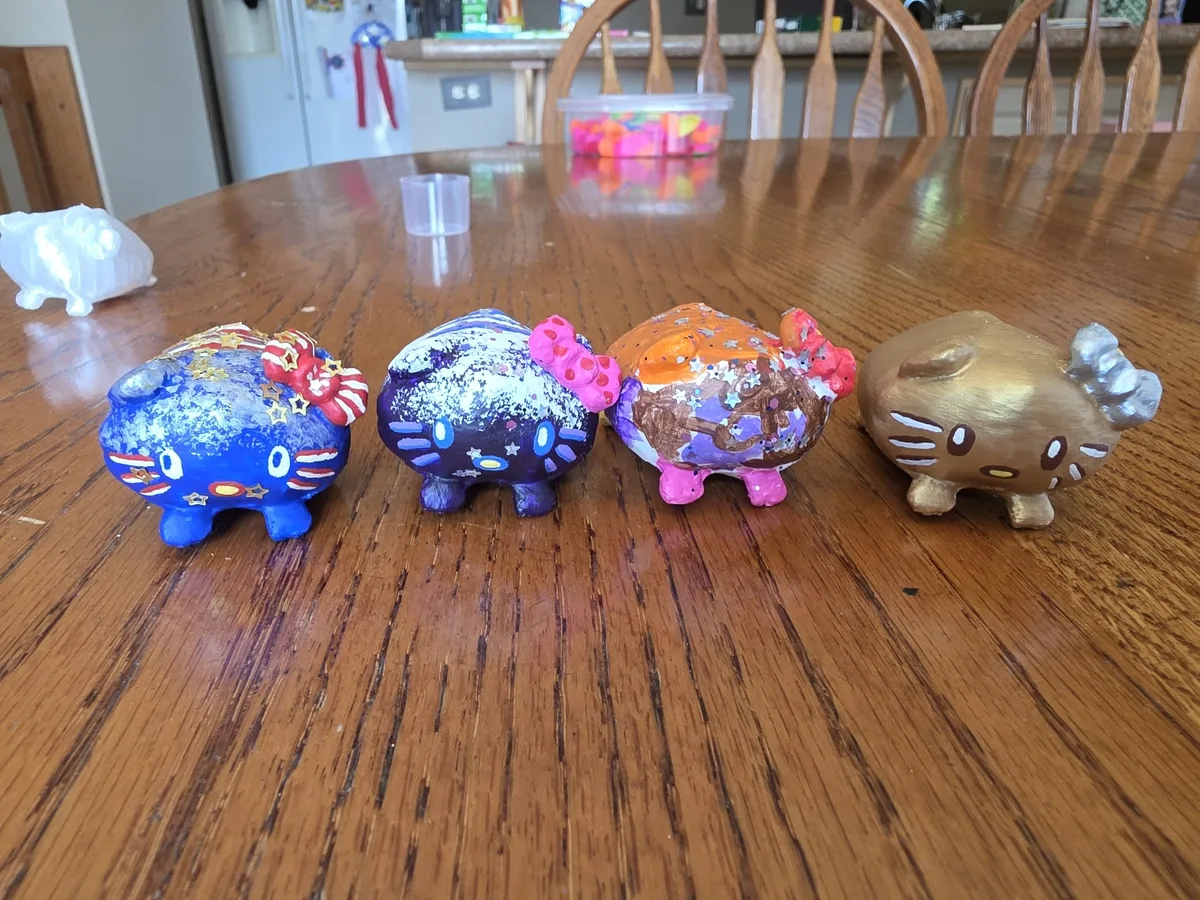 Four painted Loaf Kitty minis in a row